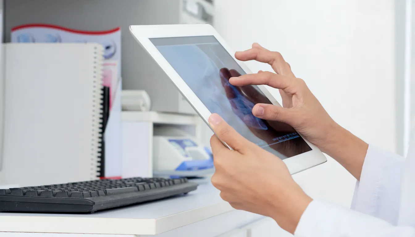hands-unrecognizable-female-doctor-looking-human-skull-x-ray-tablet